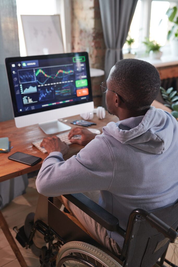 Man working on computer binomo login